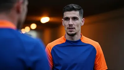 A close-up shot of a 25-year-old, 5'11" Southampton attacker in a plain blue and orange plain cotton training top, his...