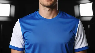 A close-up shot of an Oldham player in a blue kit with white sleeves, taken with a 50mm f/1.4 lens, with a shallow depth...